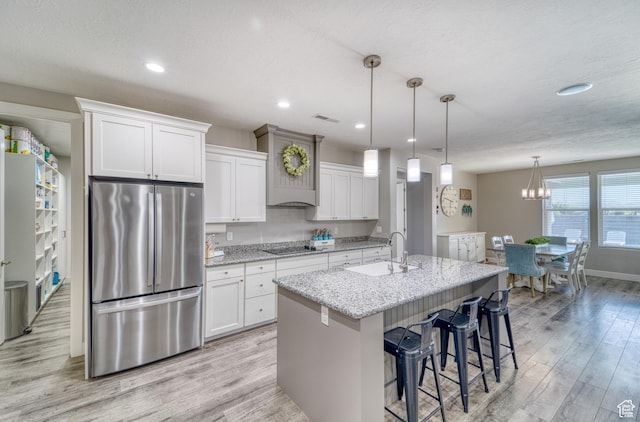3410 W 2490 S, Hurricane, UT 84737 - kitchen featuring freestanding refrigerator, black electric cooktop, light wood-type flooring, white cabinetry, and recessed lighting