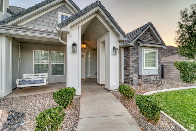 3410 W 2490 S, Hurricane, UT 84737 - entrance to property featuring covered porch, stone siding, and stucco siding