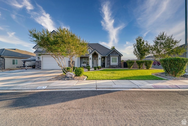 3410 W 2490 S, Hurricane, UT 84737 - view of front of home with stone siding, driveway, an attached garage, a front yard, and stucco siding