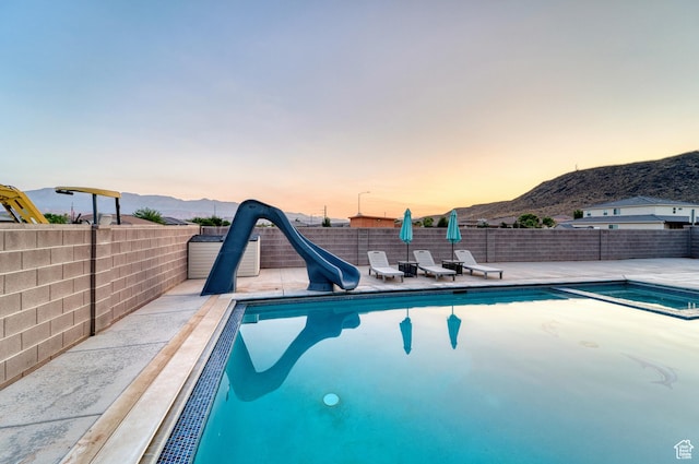 3410 W 2490 S, Hurricane, UT 84737 - view of pool with a water slide, a mountain view, and a patio