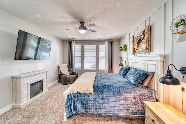 3410 W 2490 S, Hurricane, UT 84737 - carpeted bedroom featuring a glass covered fireplace, a textured ceiling, ceiling fan, and recessed lighting