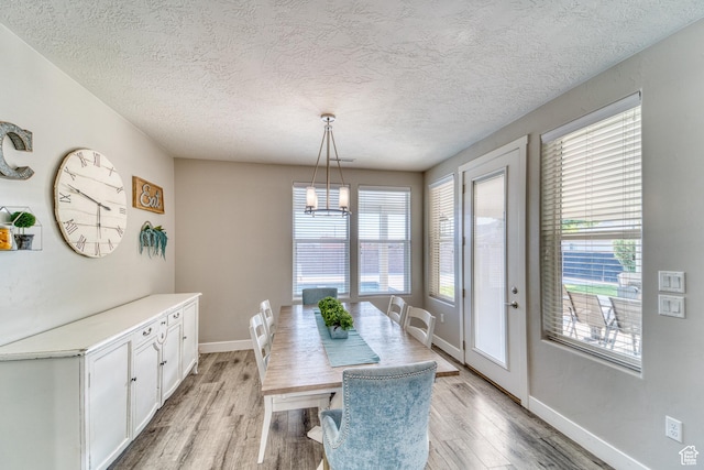 3410 W 2490 S, Hurricane, UT 84737 - dining space featuring light wood finished floors, a textured ceiling, and a chandelier