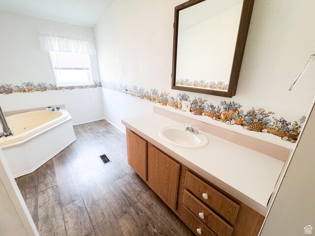 912 S W Redview Dr, Monroe, UT 84754 - bathroom featuring vanity, a whirlpool tub, and wood finished floors