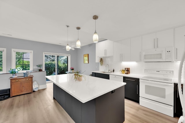 468 N E St, Salt Lake City, UT 84103 - kitchen with white appliances, white cabinetry, light wood-style floors, and light countertops