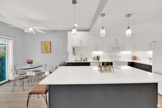 468 N E St, Salt Lake City, UT 84103 - kitchen with white appliances, white cabinets, modern cabinets, an island with sink, and recessed lighting