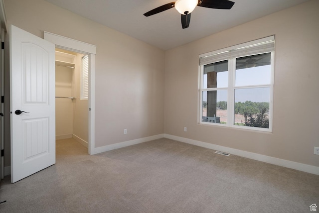 10371 N 400 W, Roosevelt, UT 84066 - unfurnished bedroom with light colored carpet, a walk in closet, a ceiling fan, and a closet