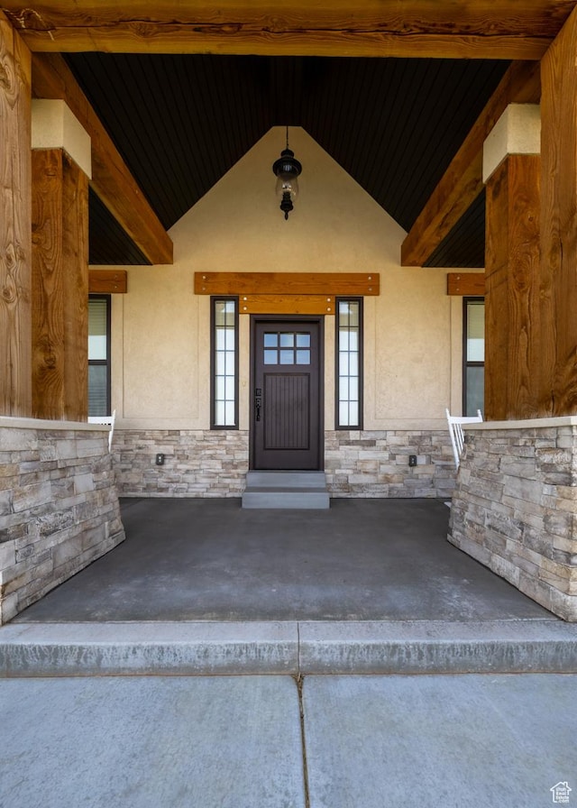 10371 N 400 W, Roosevelt, UT 84066 - property entrance featuring stone siding, stucco siding, and covered porch