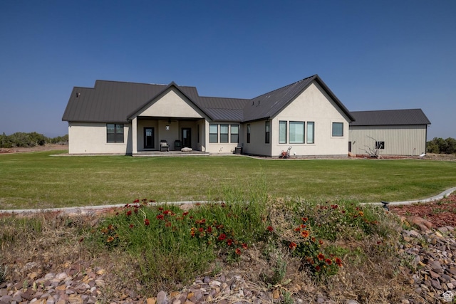 10371 N 400 W, Roosevelt, UT 84066 - rear view of house featuring a metal roof, a lawn, a patio, and stucco siding