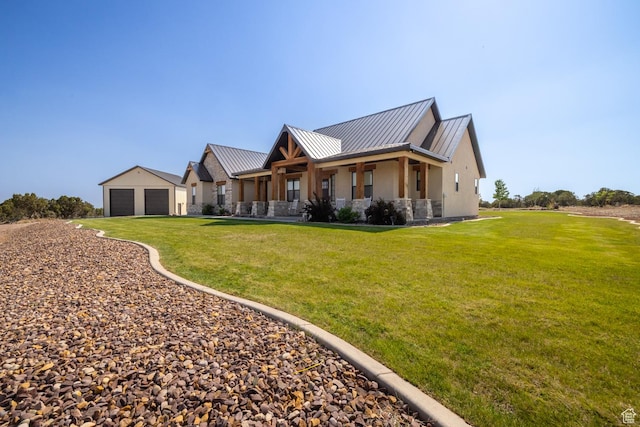 10371 N 400 W, Roosevelt, UT 84066 - view of front facade featuring stone siding, a standing seam roof, stucco siding, a garage, and a front lawn