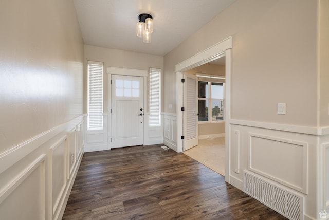 10371 N 400 W, Roosevelt, UT 84066 - foyer entrance featuring a decorative wall, dark wood finished floors, and a wainscoted wall