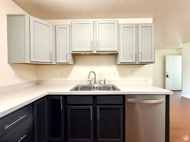 2421 N 400 E Unit E7, North Ogden, UT 84414 - kitchen with stainless steel dishwasher, wood finished floors, light countertops, and a textured ceiling