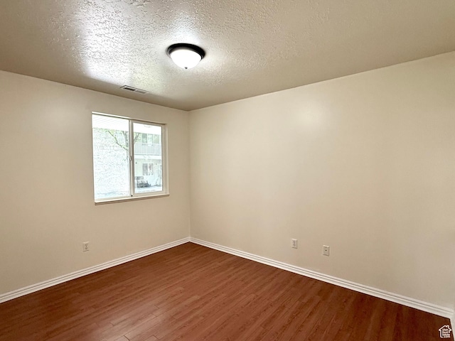 2421 N 400 E Unit E7, North Ogden, UT 84414 - unfurnished room featuring dark wood-style floors and a textured ceiling