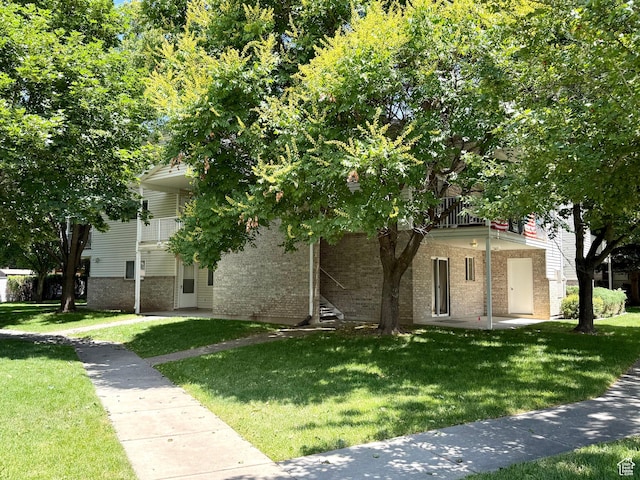 2421 N 400 E Unit E7, North Ogden, UT 84414 - obstructed view of property featuring brick siding and a front yard
