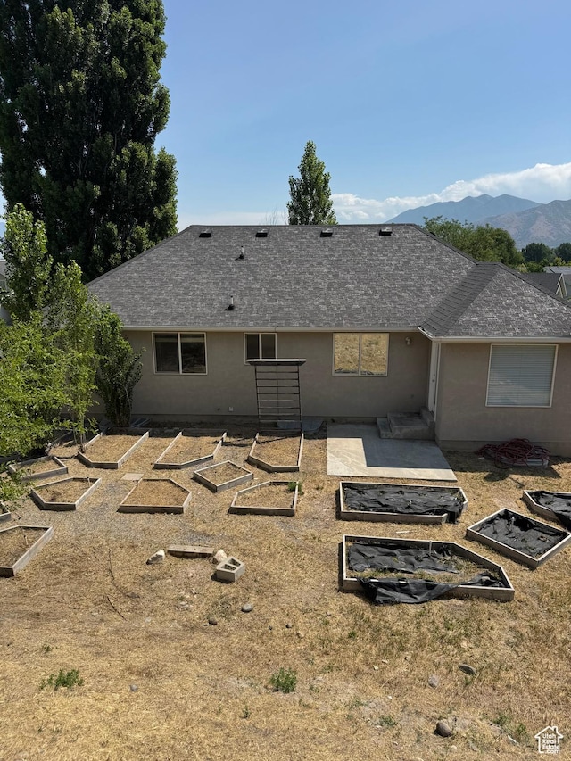 584 S Loafer Dr, Payson, UT 84651 - rear view of house featuring a garden, a shingled roof, and a mountain view