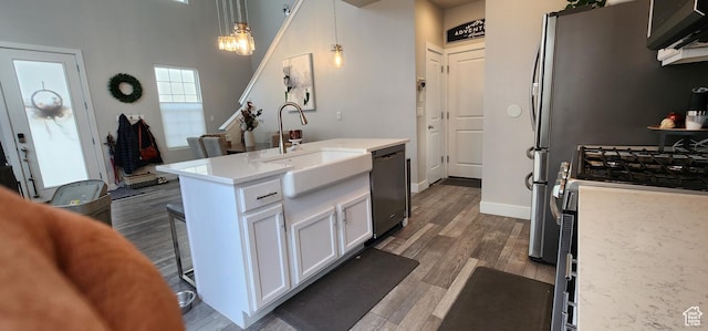 5332 W Scout Plane Ln, South Jordan, UT 84009 - kitchen featuring appliances with stainless steel finishes, white cabinets, pendant lighting, a chandelier, and dark wood-style flooring