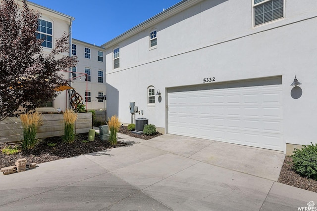 5332 W Scout Plane Ln, South Jordan, UT 84009 - view of side of property with stucco siding, a garage, and concrete driveway