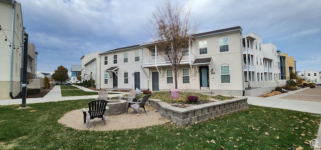 5332 W Scout Plane Ln, South Jordan, UT 84009 - view of front of house featuring a residential view, a fire pit, a front yard, and stucco siding