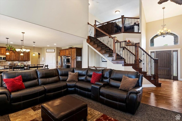 469 W 5700 S, Washington Terrace, UT 84405 - living room featuring a chandelier, hardwood / wood-style floors, a towering ceiling, and stairway