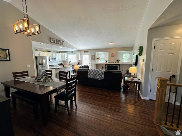 8675 S Pebblecreek Rd, West Jordan, UT 84081 - dining area with dark wood finished floors, a chandelier, lofted ceiling, and a textured ceiling
