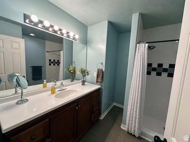 8675 S Pebblecreek Rd, West Jordan, UT 84081 - full bathroom with vanity, a tile shower, a textured ceiling, and tile patterned floors