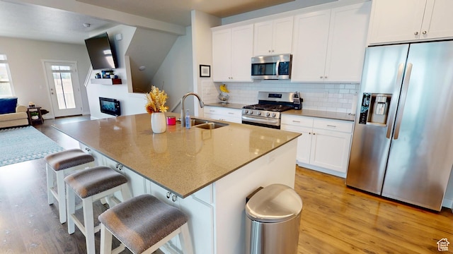 11393 S Prosperity Rd W, South Jordan, UT 84009 - kitchen with stainless steel appliances, light wood finished floors, tasteful backsplash, and white cabinets