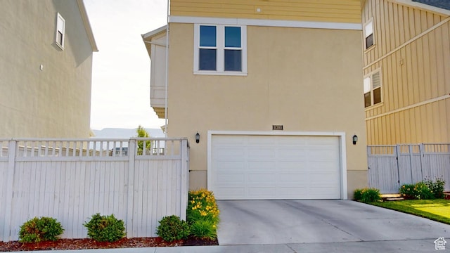 11393 S Prosperity Rd W, South Jordan, UT 84009 - view of front of home with a garage, stucco siding, and concrete driveway