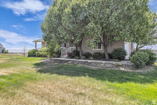4301 N Majors St E, Eagle Mountain, UT 84005 - view of front of property with a front lawn and stucco siding