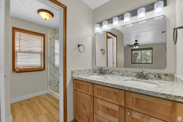 4301 N Majors St E, Eagle Mountain, UT 84005 - full bath featuring a marble finish shower, wood finished floors, double vanity, and ceiling fan