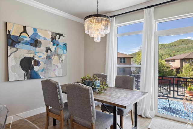 1348 Fiddich Glen Ln, Park City, UT 84098 - dining space featuring a chandelier, ornamental molding, wood finished floors, plenty of natural light, and a mountain view