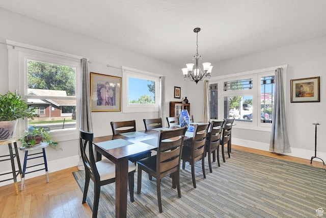 1203 25th St, Ogden, UT 84401 - dining room featuring light wood-type flooring, plenty of natural light, and a chandelier