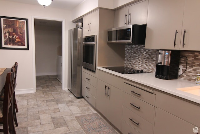 1785 29th Unit 301, Ogden, UT 84403 - kitchen featuring appliances with stainless steel finishes, decorative backsplash, light countertops, and stone finish floors