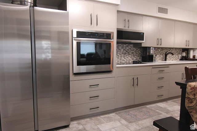 1785 29th Unit 301, Ogden, UT 84403 - kitchen with stainless steel appliances, tasteful backsplash, light countertops, and stone finish flooring