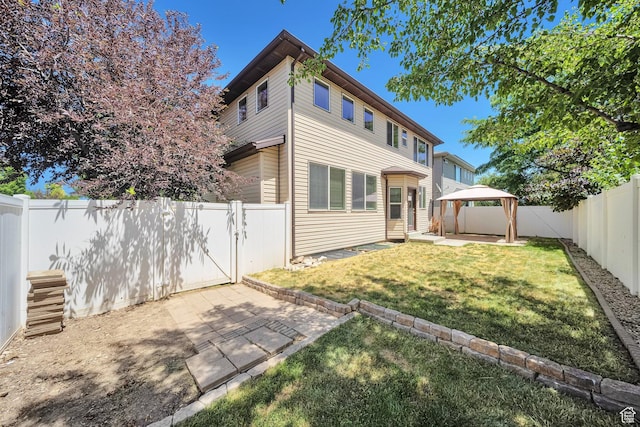 5961 W Chiswick Ct, West Jordan, UT 84081 - rear view of house with a gazebo, entry steps, a patio, and a fenced backyard