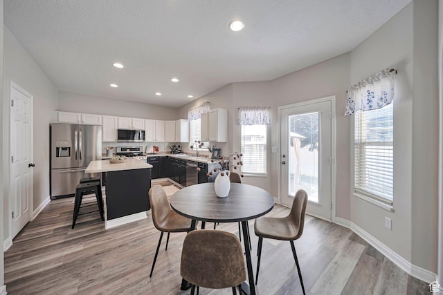 5961 W Chiswick Ct, West Jordan, UT 84081 - dining area with light wood-style flooring and recessed lighting