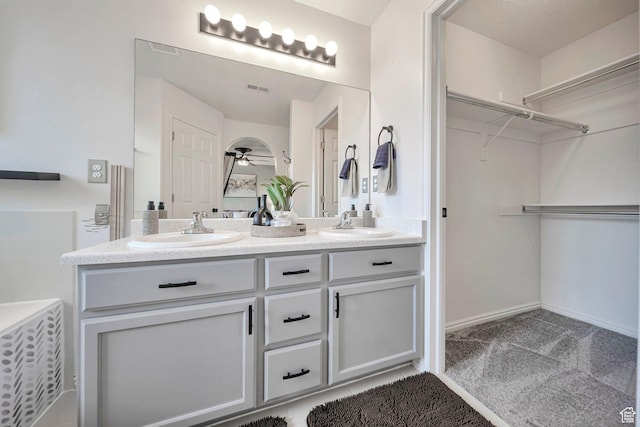 5961 W Chiswick Ct, West Jordan, UT 84081 - bathroom with double vanity, a ceiling fan, and a spacious closet