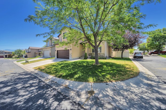 5961 W Chiswick Ct, West Jordan, UT 84081 - obstructed view of property with concrete driveway, a front lawn, stucco siding, and stone siding