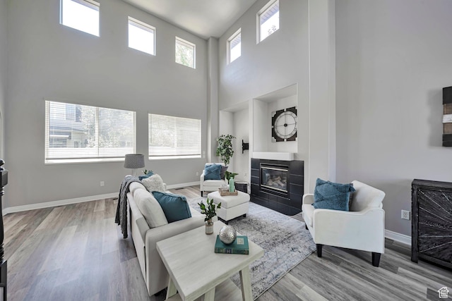 5961 W Chiswick Ct, West Jordan, UT 84081 - living room with a high ceiling, a fireplace, and wood finished floors