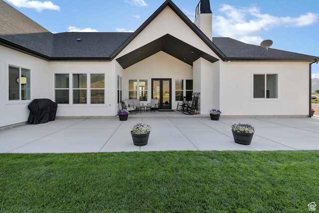 1952 N Sr 118, Monroe, UT 84754 - back of property with a chimney, stucco siding, a lawn, roof with shingles, and a patio