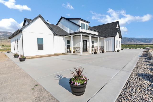 1952 N Sr 118, Monroe, UT 84754 - rear view of property featuring a mountain view, covered porch, board and batten siding, and a shingled roof