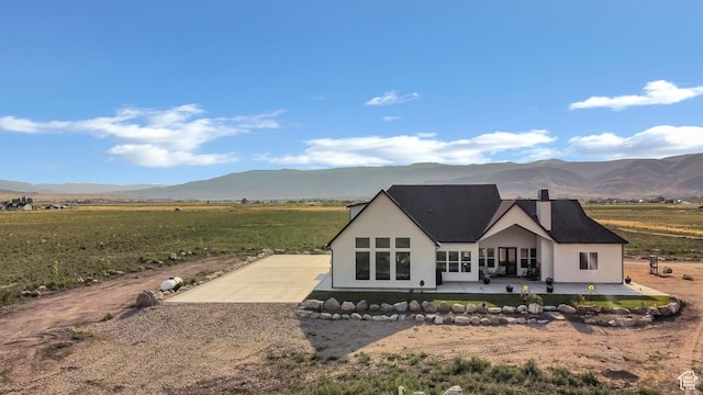 1952 N Sr 118, Monroe, UT 84754 - back of property with driveway, a patio, a mountain view, and a chimney