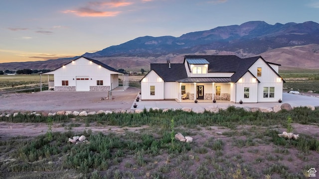 1952 N Sr 118, Monroe, UT 84754 - modern farmhouse style home with a standing seam roof, a metal roof, a mountain view, and an outbuilding