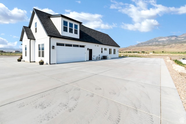 1952 N Sr 118, Monroe, UT 84754 - view of property exterior featuring driveway, a mountain view, a shingled roof, and board and batten siding