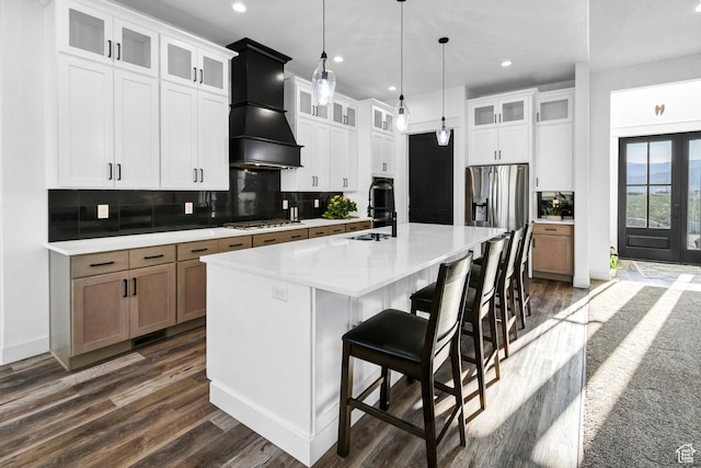 1952 N Sr 118, Monroe, UT 84754 - kitchen featuring premium range hood, dark wood-type flooring, a large island with sink, light countertops, and tasteful backsplash