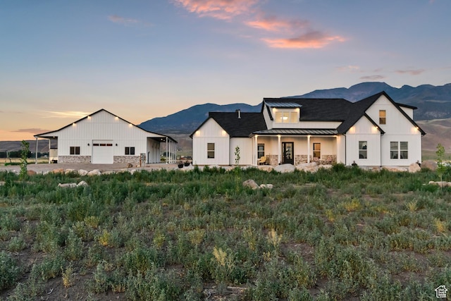 1952 N Sr 118, Monroe, UT 84754 - view of front of home featuring a standing seam roof, a metal roof, a mountain view, stone siding, and board and batten siding