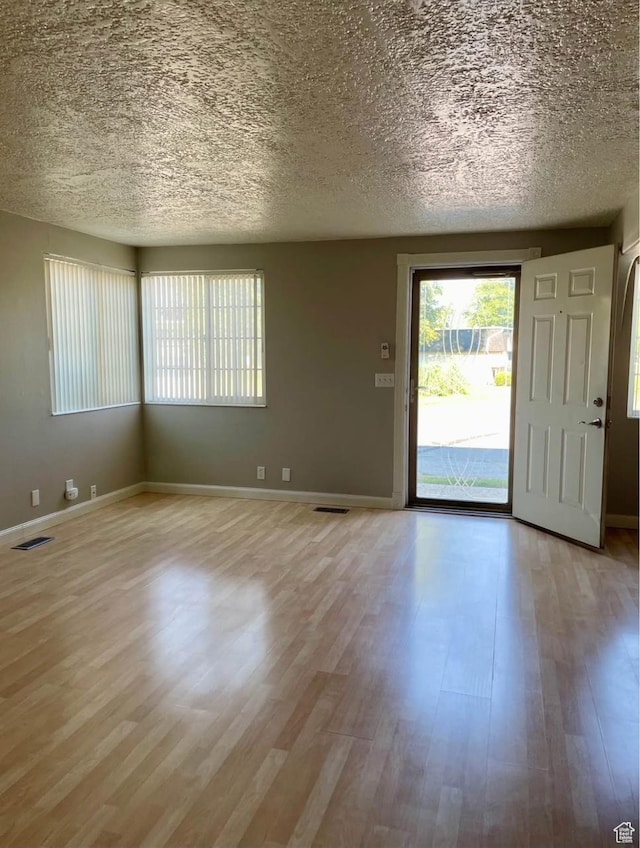 1192 W 4365 S Unit 1C, Salt Lake City, UT 84123 - entrance foyer with light wood-style floors and a textured ceiling