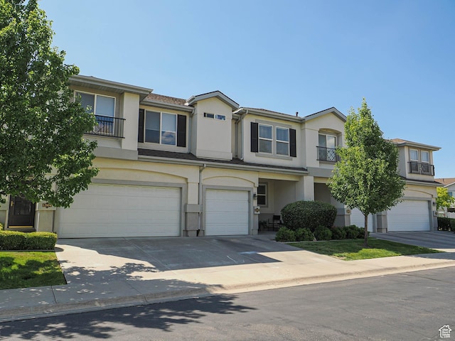 12102 S Mountain Peak Dr, Draper, UT 84020 - view of property featuring an attached garage, stucco siding, and driveway