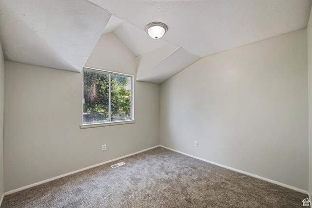 558 N Redwood Rd Unit 3, Salt Lake City, UT 84116 - bonus room with carpet flooring, lofted ceiling, and a textured ceiling