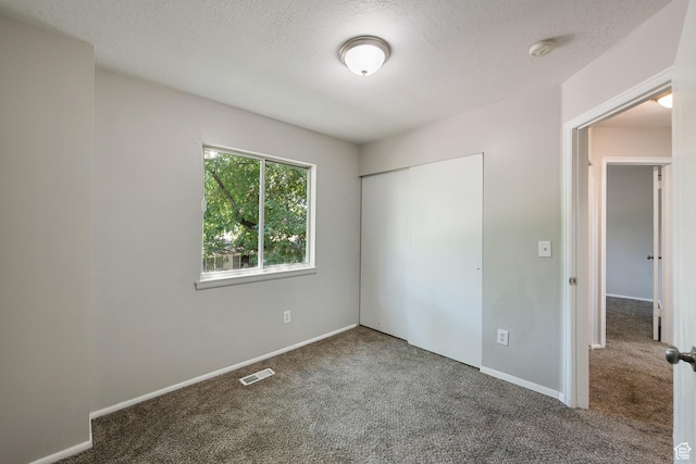558 N Redwood Rd Unit 3, Salt Lake City, UT 84116 - unfurnished bedroom with carpet, a textured ceiling, and a closet