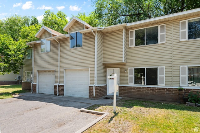 558 N Redwood Rd Unit 3, Salt Lake City, UT 84116 - multi unit property featuring asphalt driveway, an attached garage, brick siding, and a front lawn