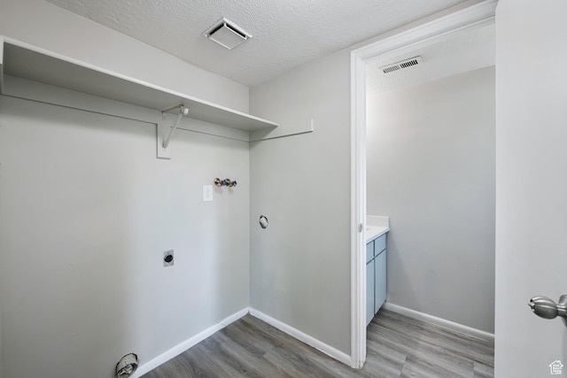 558 N Redwood Rd Unit 3, Salt Lake City, UT 84116 - laundry area featuring light wood-type flooring, hookup for an electric dryer, a textured ceiling, and hookup for a washing machine